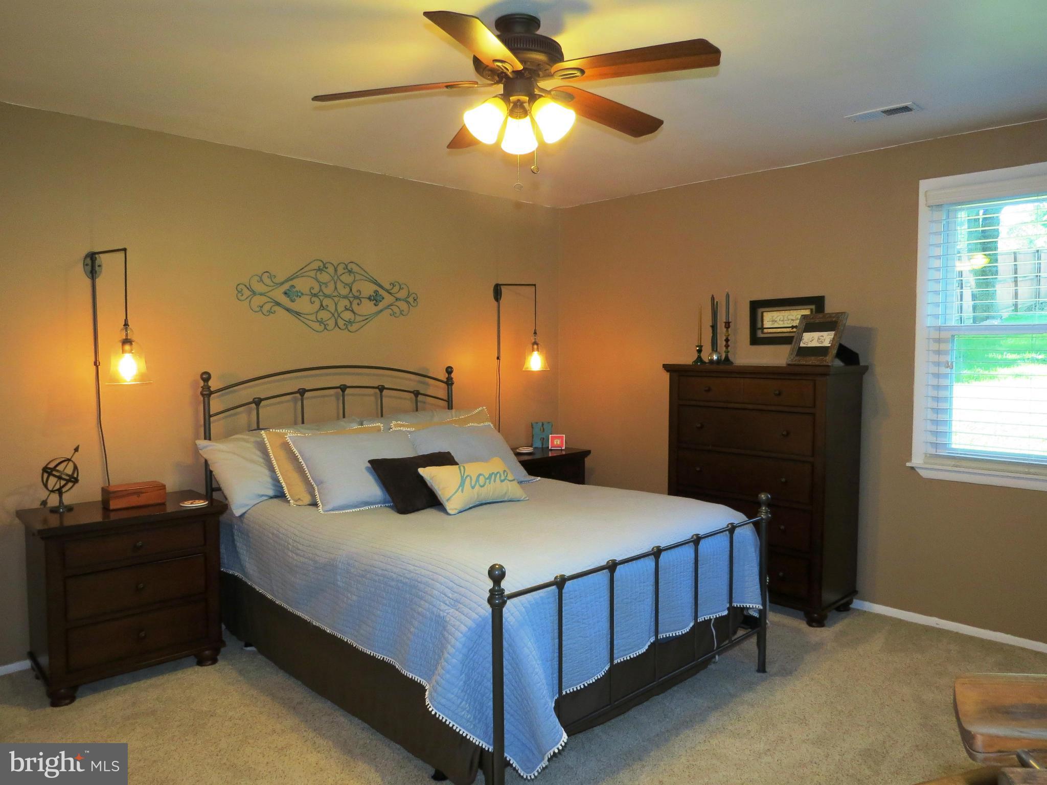 3313 Maple Grove Road Hampstead, MD 21074 - Photo 4 of 30 a bedroom with a bed and a chandelier