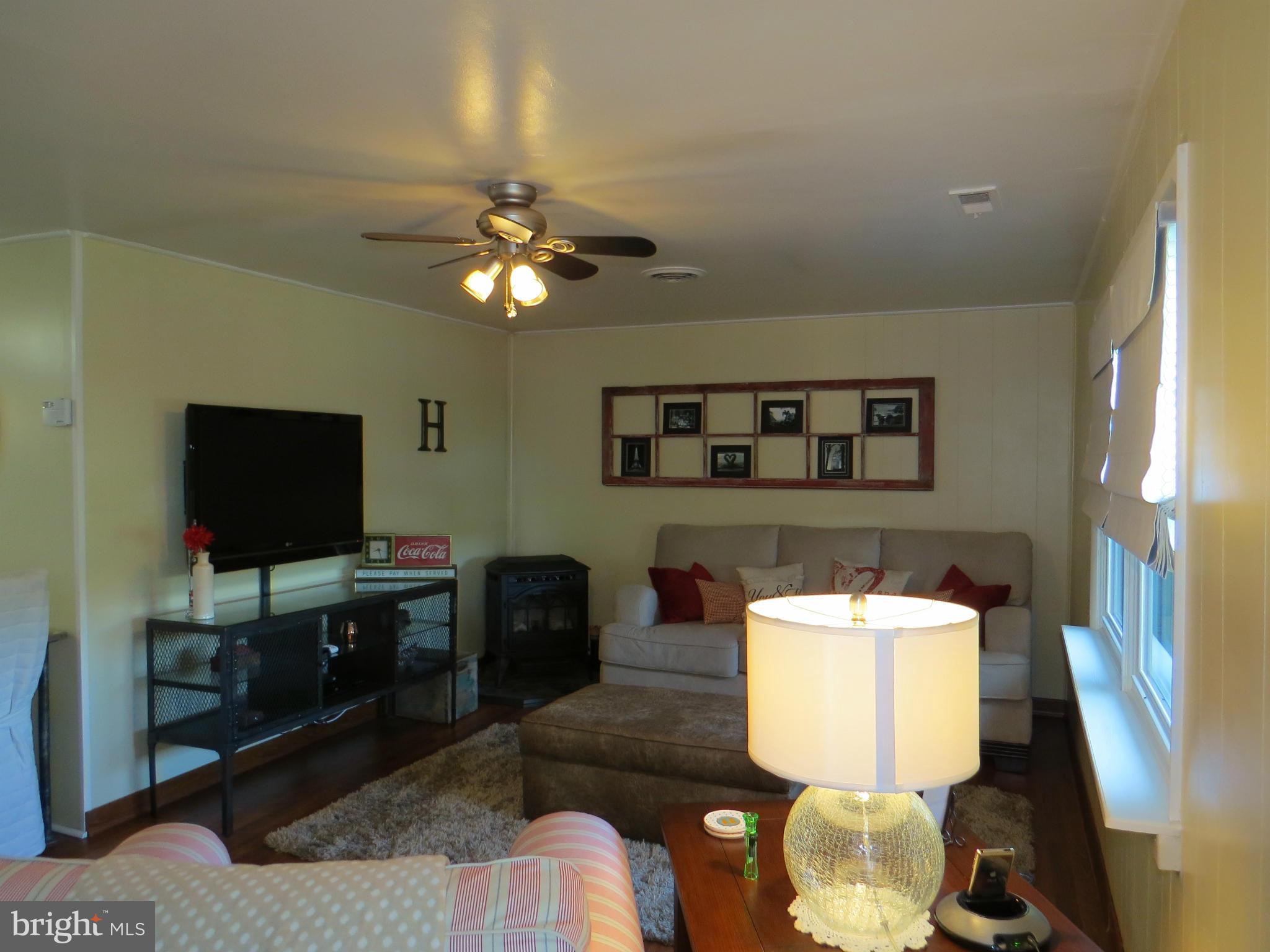 3313 Maple Grove Road Hampstead, MD 21074 - Photo 8 of 30 a living room with furniture and a flat screen tv