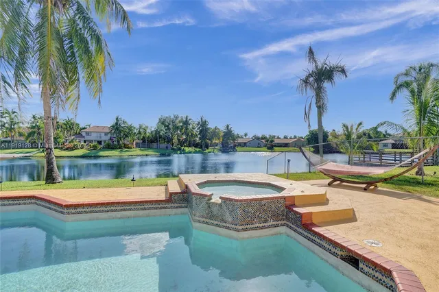 a view of a lake with couches chairs