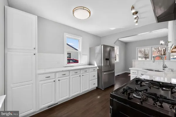 a kitchen with a stove and a refrigerator