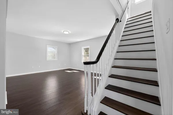 a view of entryway with wooden floor and stairs