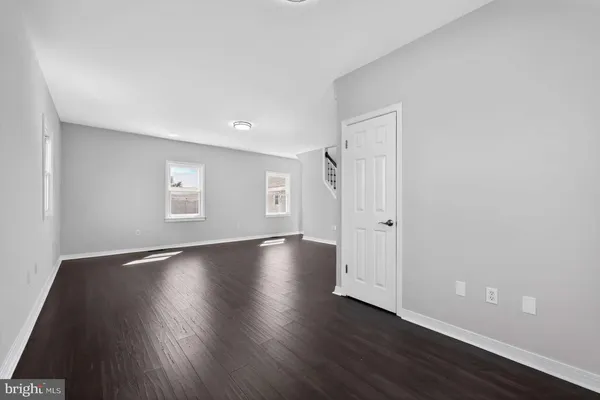 a view of a livingroom with wooden floor and window
