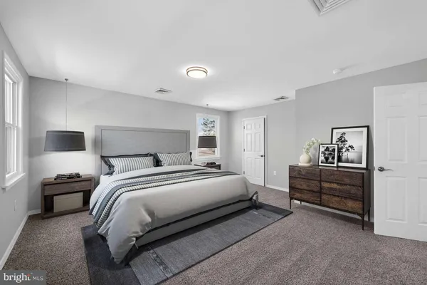 a bedroom with a bed and a night stand