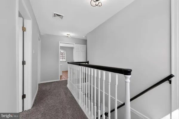 a view of a hallway with stairs