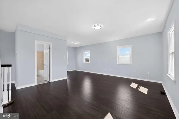 a view of a livingroom with wooden floor and window