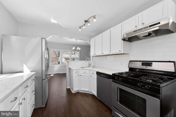 a kitchen with stainless steel appliances a white stove top oven and sink
