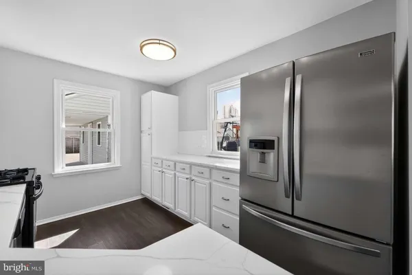 a kitchen with stainless steel appliances a refrigerator sink and cabinets