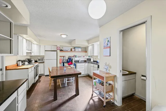 a room with furniture and a kitchen view
