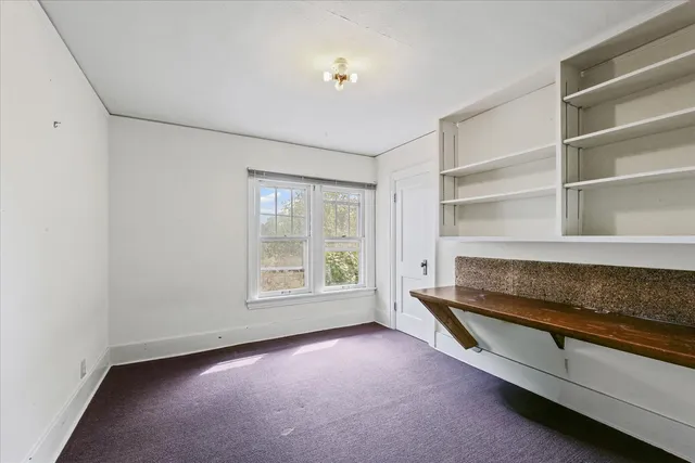 a view of room with window and cabinet