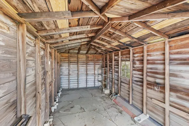 a view of a house with a small yard plants and large tree