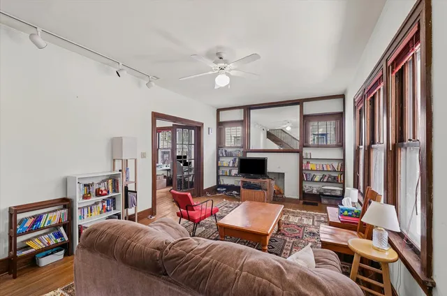a living room with furniture a fireplace and a large window