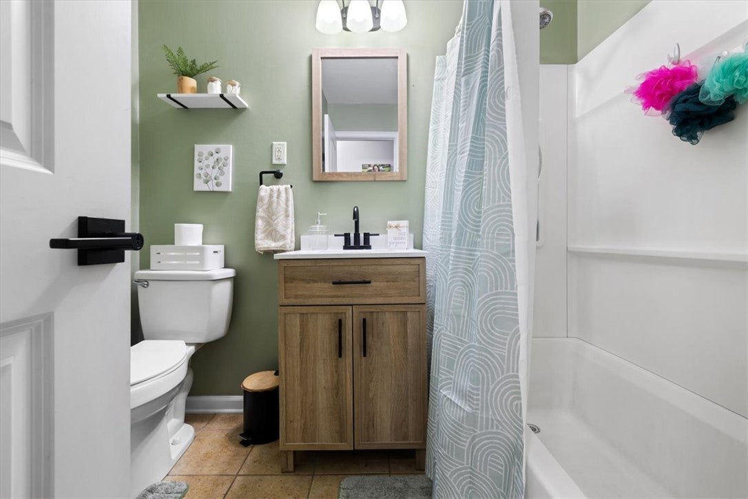 1482 Lee Road Troy, OH 45373 - Photo 10 of 30 This bathroom features a contemporary vanity and a classic shower-tub combination.