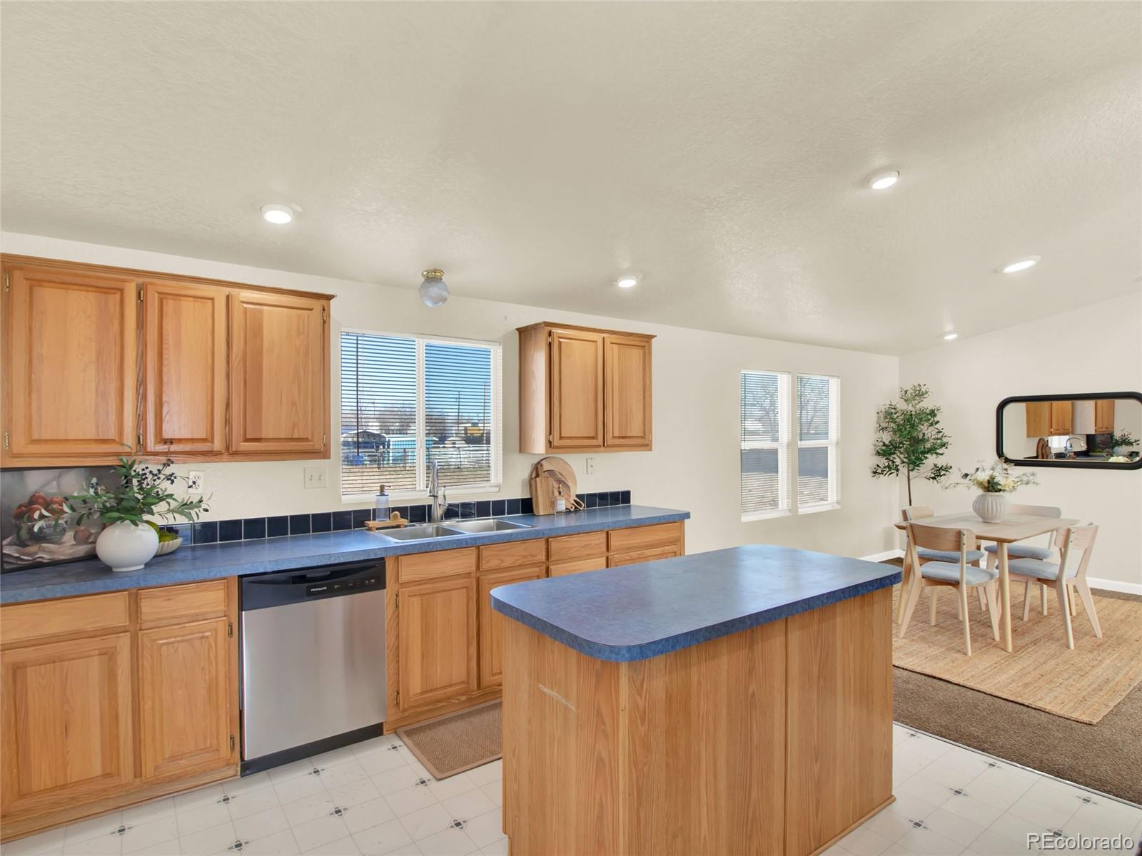 7798 Richard Avenue Fort Lupton, CO 80621 - Photo 13 of 45 a kitchen with lots of counter top space and dining table