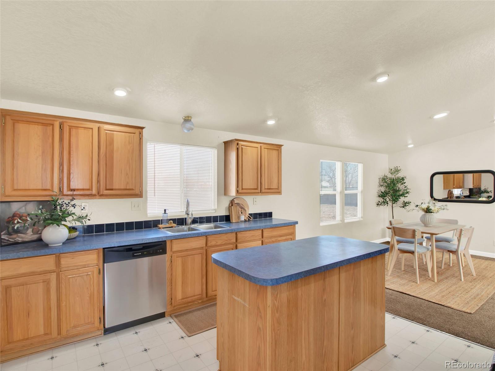 7798 Richard Avenue Fort Lupton, CO 80621 - Photo 14 of 45 a kitchen with lots of counter top space and dining table