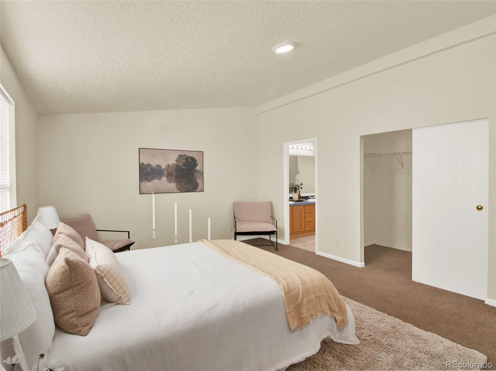 7798 Richard Avenue Fort Lupton, CO 80621 - Photo 17 of 45 a bedroom with a bed and a painting