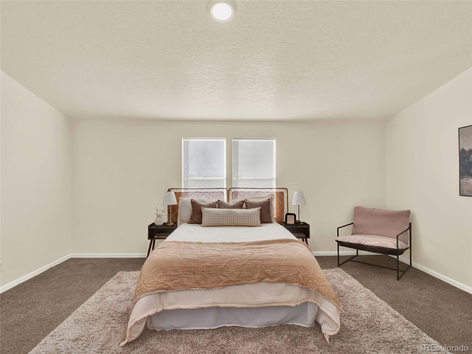 7798 Richard Avenue Fort Lupton, CO 80621 - Photo 18 of 45 a bedroom with a bed and a window