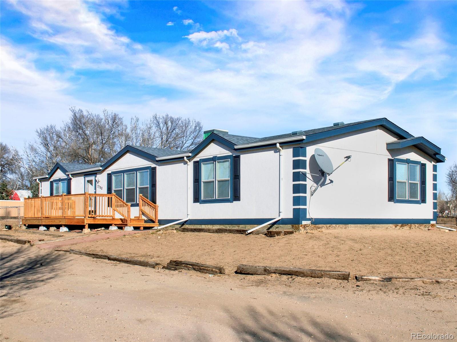 7798 Richard Avenue Fort Lupton, CO 80621 - Photo 2 of 45 a view of the house with a yard