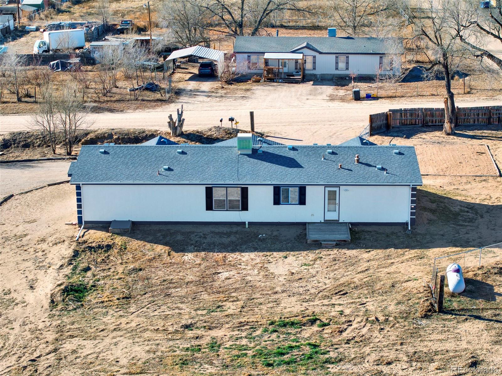 7798 Richard Avenue Fort Lupton, CO 80621 - Photo 37 of 45 a front view of a house with a yard