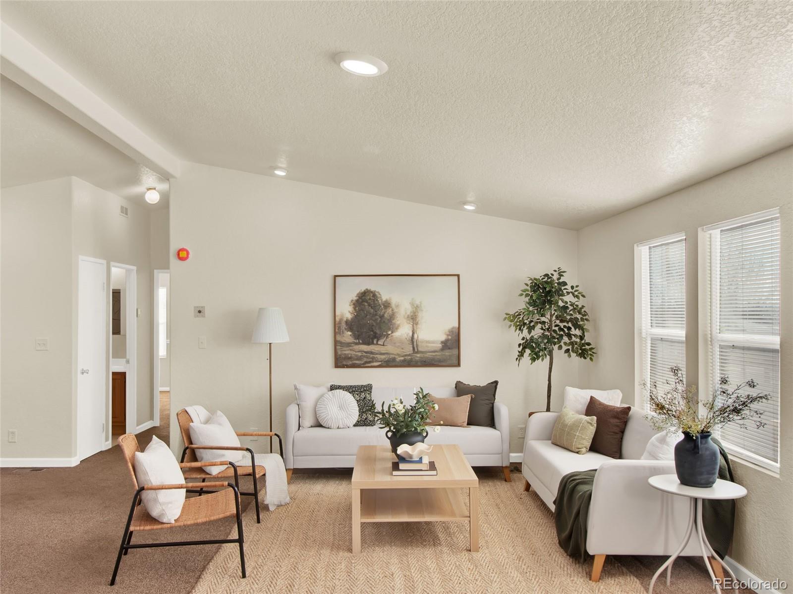 7798 Richard Avenue Fort Lupton, CO 80621 - Photo 6 of 45 a living room with furniture and a large window