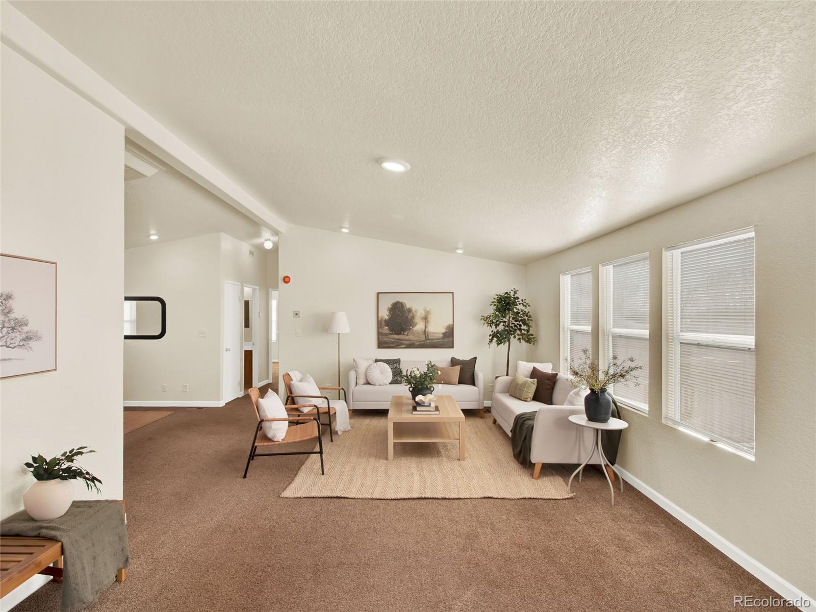 7798 Richard Avenue Fort Lupton, CO 80621 - Photo 7 of 45 a living room with furniture and a large window