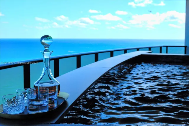 a large bedroom with a large bed and glass window