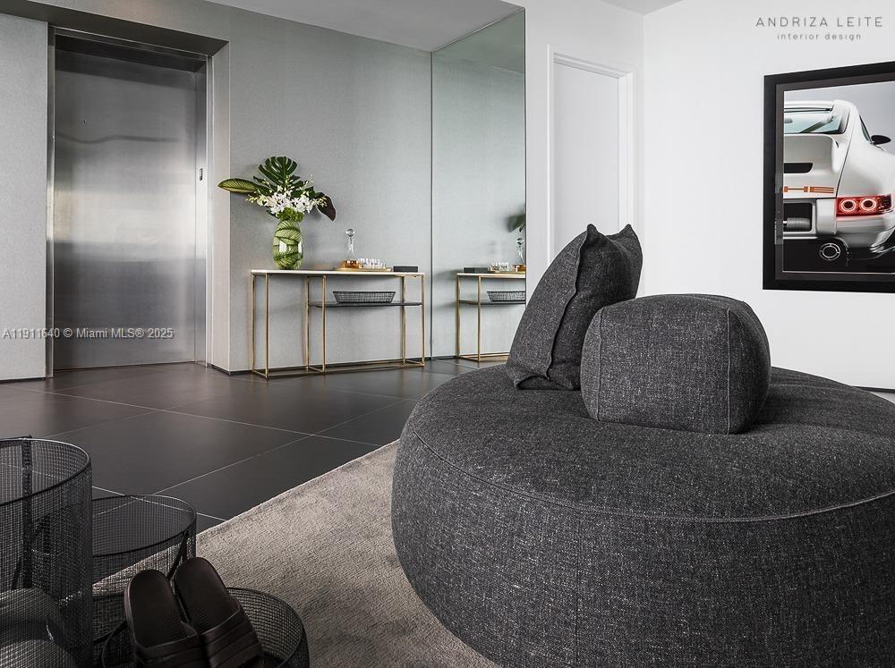 18555 Collins Avenue, Unit 3005 Sunny Isles Beach, FL 33160 - Photo 18 of 57 a living room with furniture and a potted plant