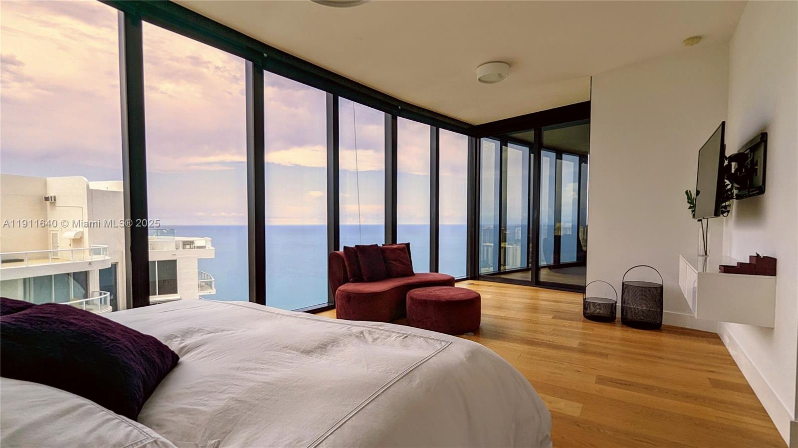 18555 Collins Avenue, Unit 3005 Sunny Isles Beach, FL 33160 - Photo 24 of 57 a bedroom with a large bed and a large window