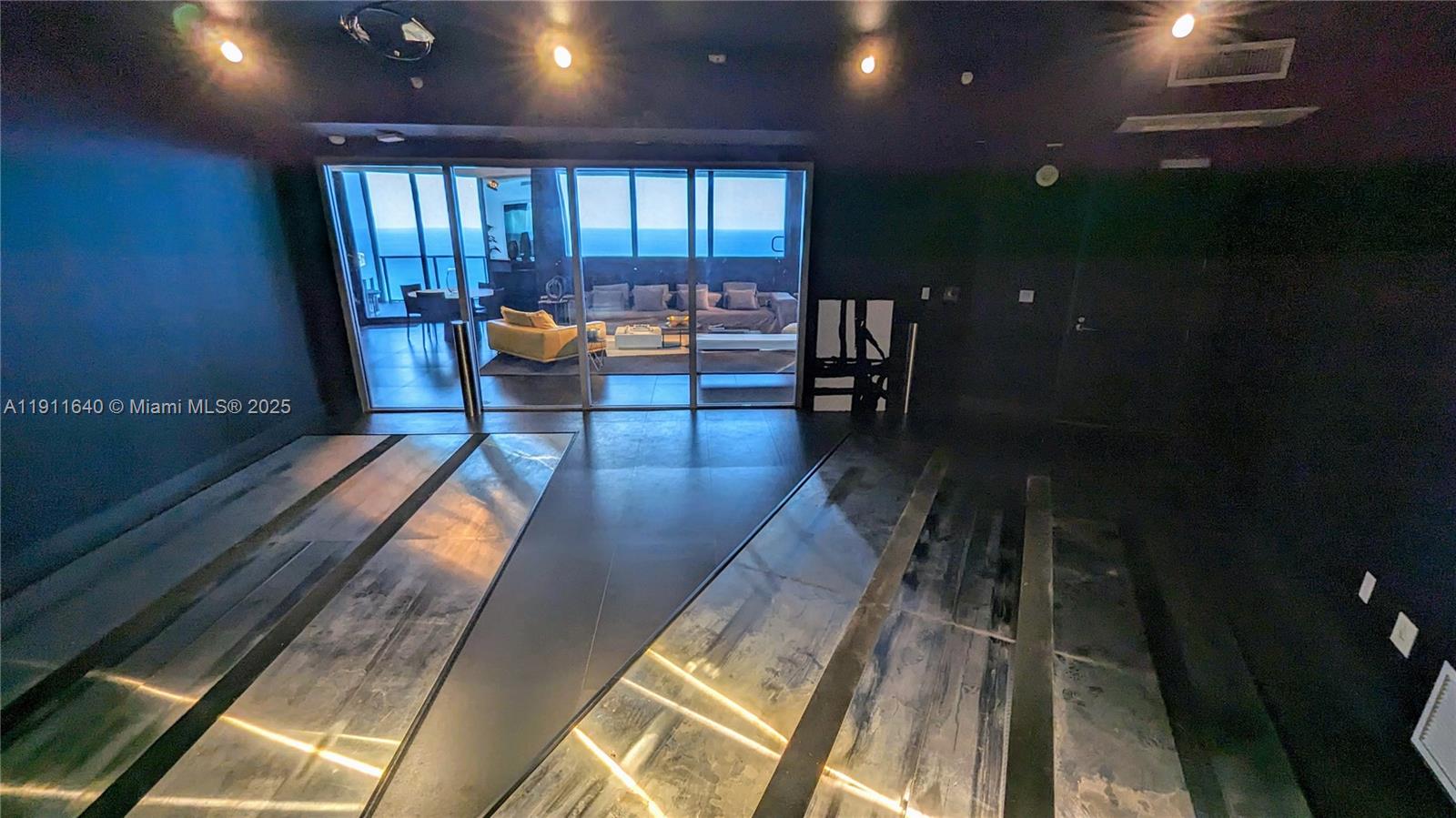 18555 Collins Avenue, Unit 3005 Sunny Isles Beach, FL 33160 - Photo 38 of 57 a lobby with furniture and rug