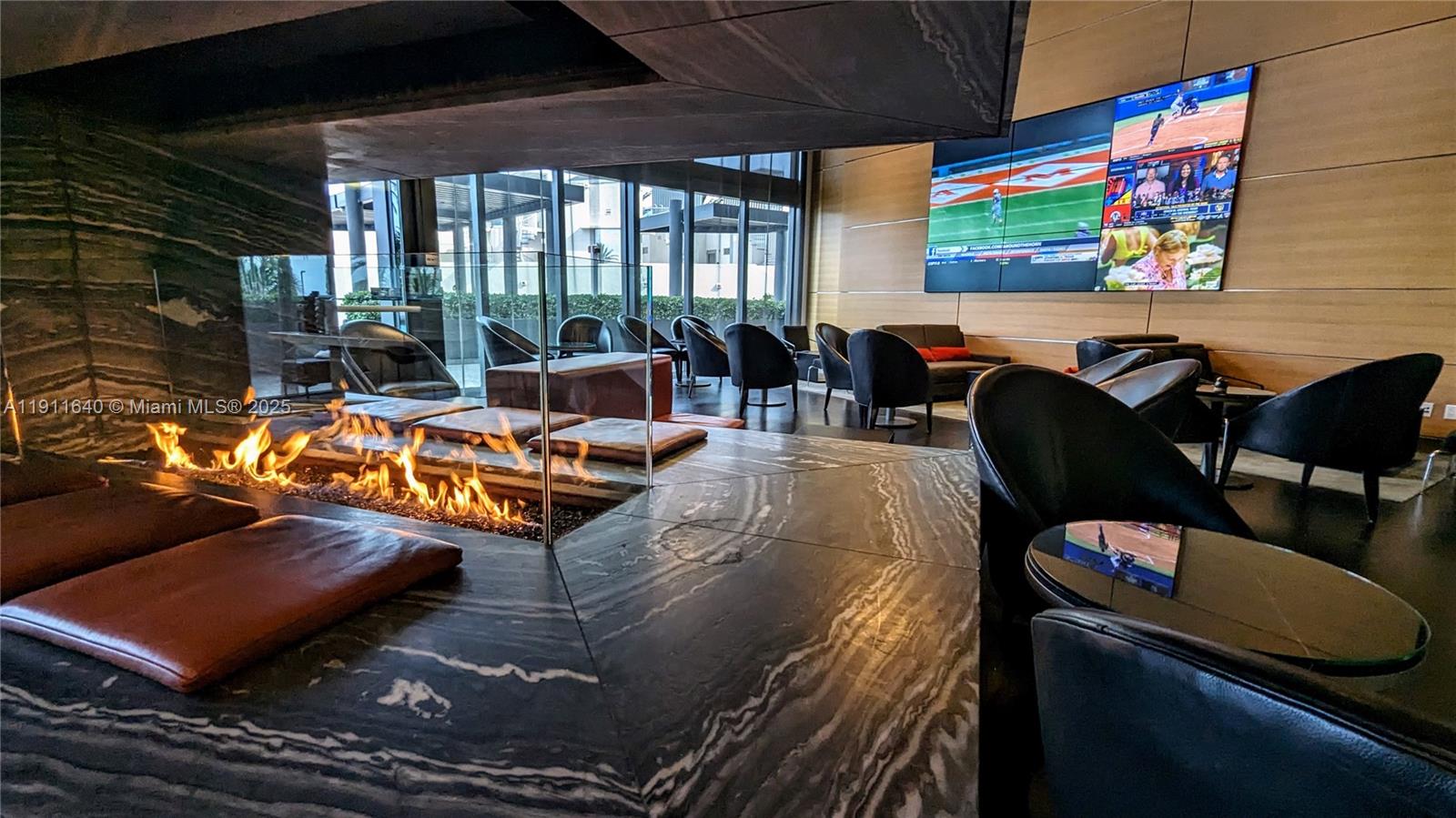 18555 Collins Avenue, Unit 3005 Sunny Isles Beach, FL 33160 - Photo 45 of 57 a living room with furniture and a flat screen tv