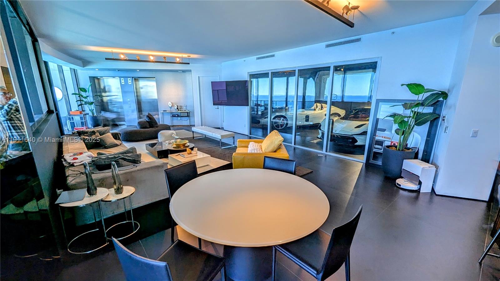 18555 Collins Avenue, Unit 3005 Sunny Isles Beach, FL 33160 - Photo 5 of 57 a living room with furniture and wooden floor