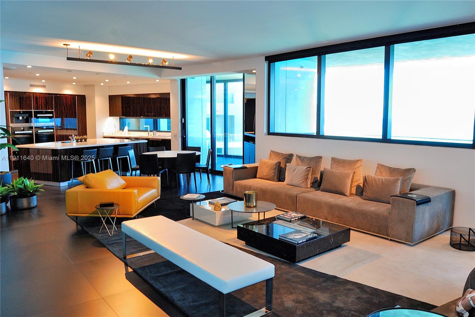 18555 Collins Avenue, Unit 3005 Sunny Isles Beach, FL 33160 - Photo 9 of 57 a living room with furniture and a flat screen tv