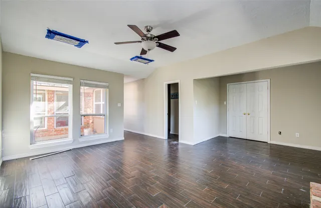 a view of a backyard with large trees
