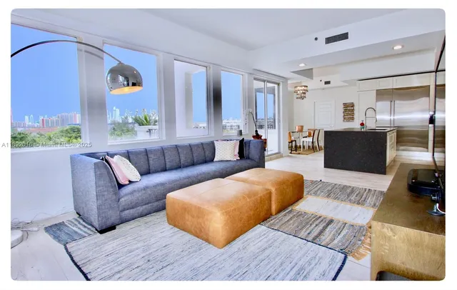 a living room with kitchen island furniture and a chandelier