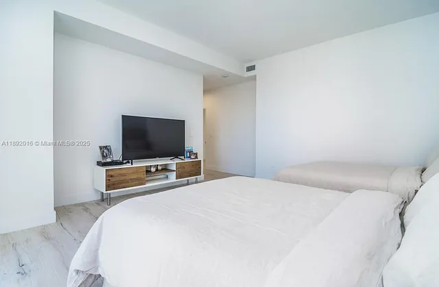 a bathroom with a shower a toilet and sink