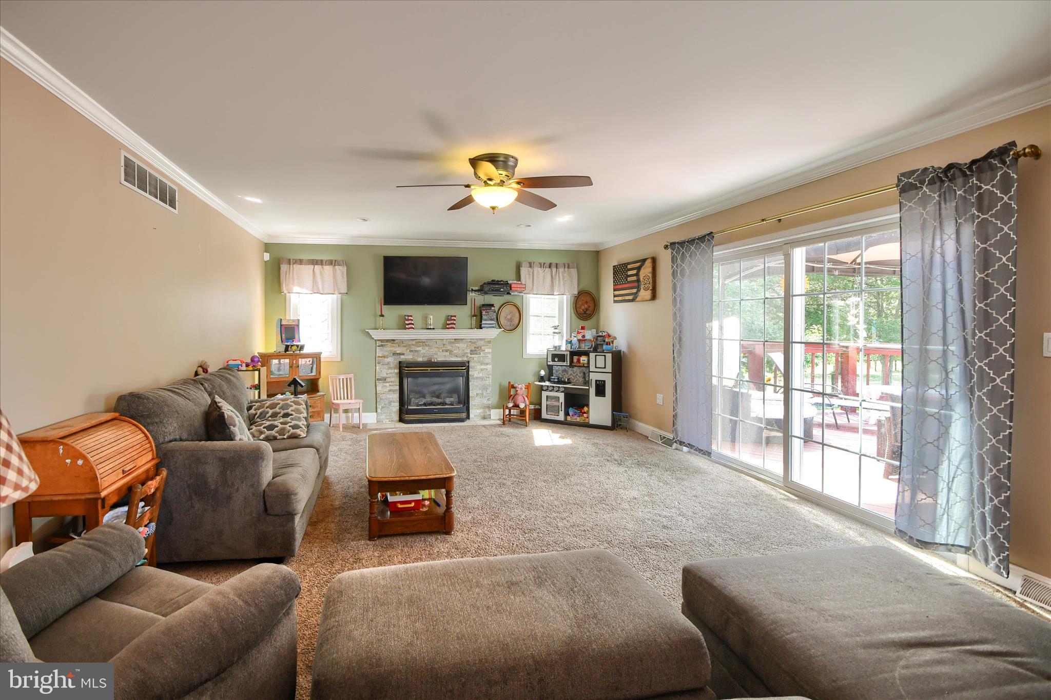 1010 Sweetbriar Road Perkasie, PA 18944 - Photo 18 of 59 a living room with furniture a fireplace and a flat screen tv