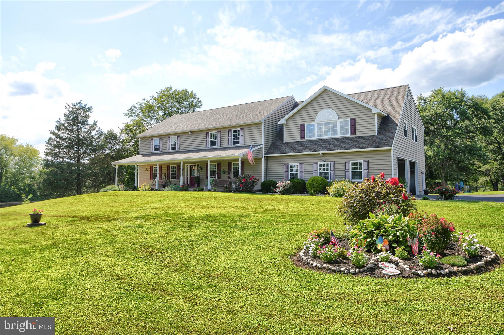 1010 Sweetbriar Road Perkasie, PA 18944 - Photo 2 of 59 a front view of a house with a garden and porch