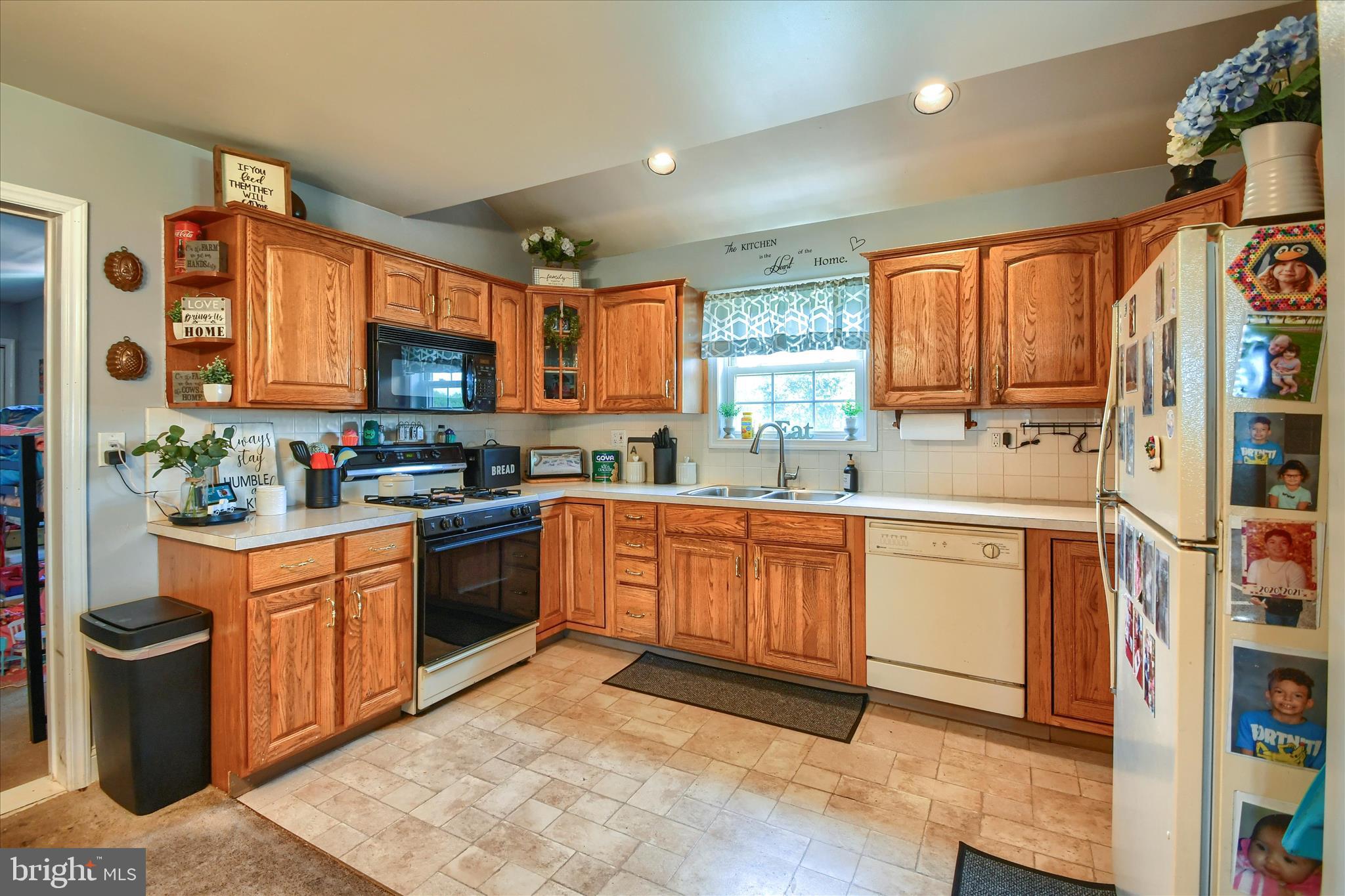 1010 Sweetbriar Road Perkasie, PA 18944 - Photo 33 of 59 a kitchen with stainless steel appliances granite countertop a refrigerator sink and wooden cabinets
