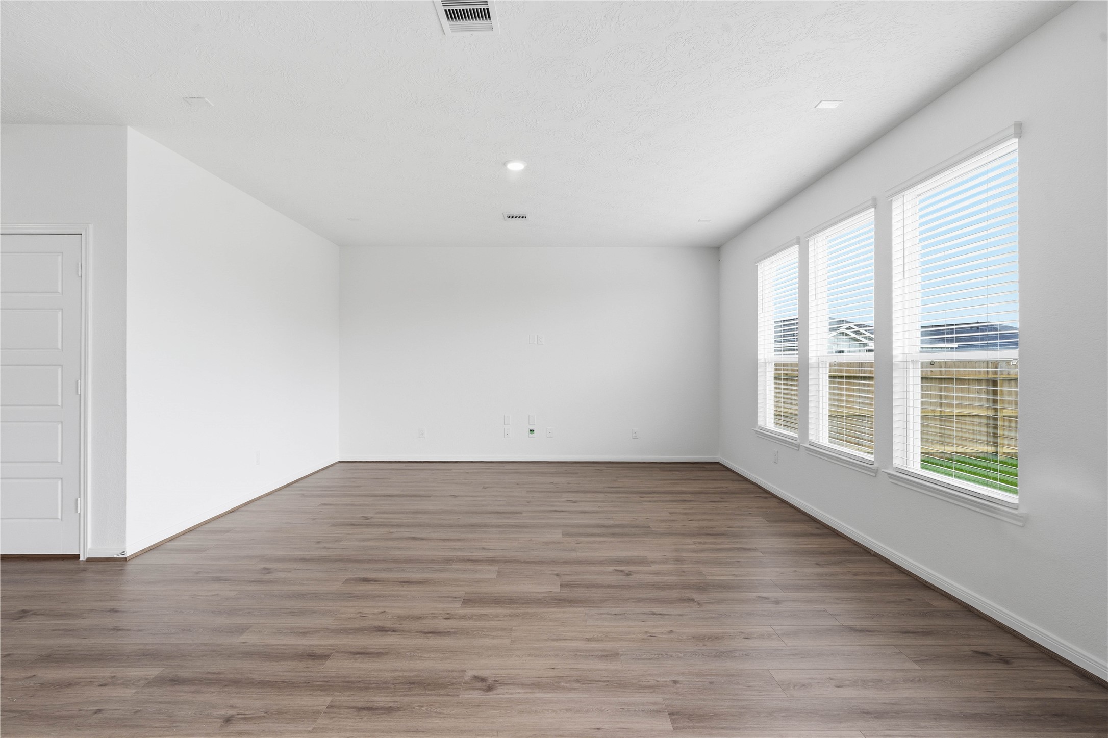 2503 Spruce Hl Road Beasley, TX 77417 - Photo 11 of 31 Bring family and friends together in this beautiful family room! It features high ceilings, recessed lighting, custom paint, stunning vinyl plank flooring, and large windows!