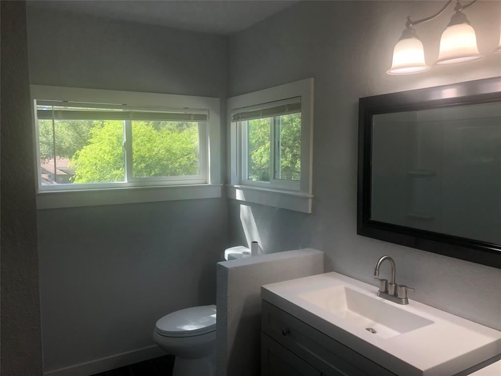 10310 Gail Road, Unit B Austin, TX 78748 - Photo 7 of 12 A well-lit bathroom features a modern vanity and windows offering natural light.