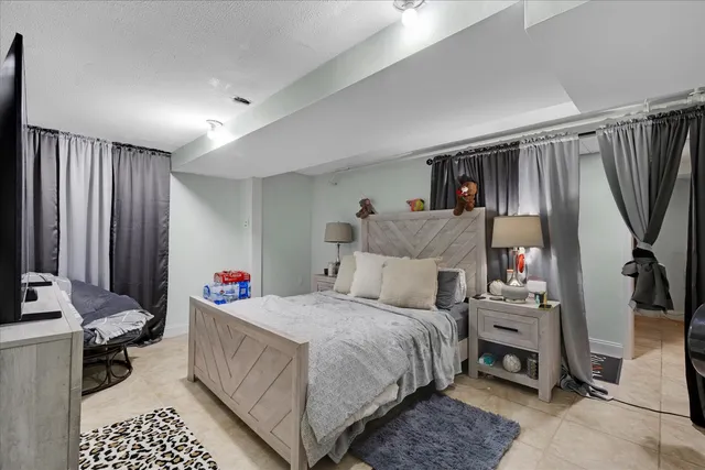 a bedroom with bed and a window