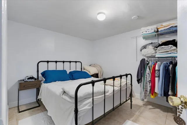 a view of a bedroom with furniture and closet