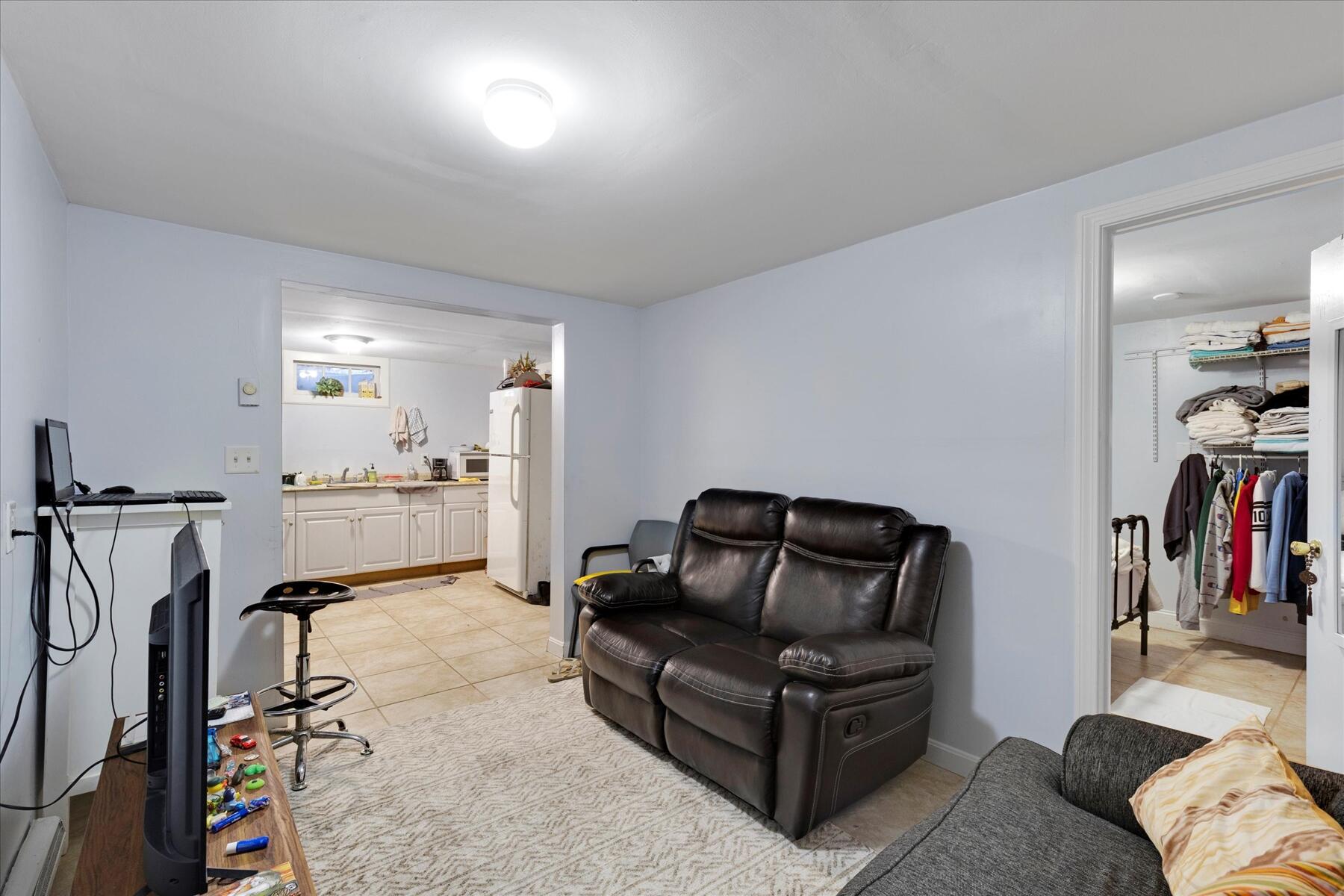 423 Lincoln Rd Extension Hyannis, MA 02601 - Photo 17 of 17 a living room with furniture and a gym machine with wooden floor