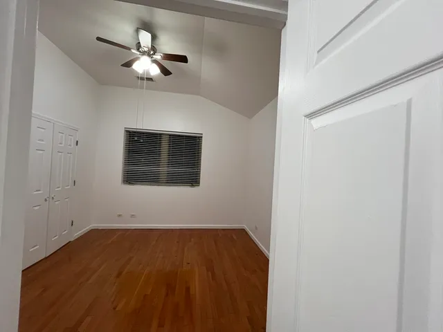 a view of a room with wooden floor and white walls