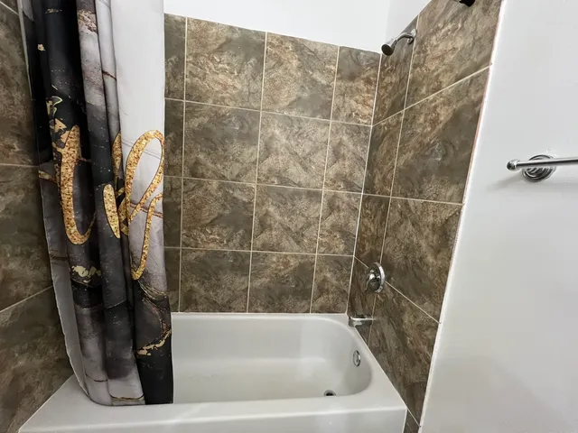 a bath tub sitting next to a white sink and vanity