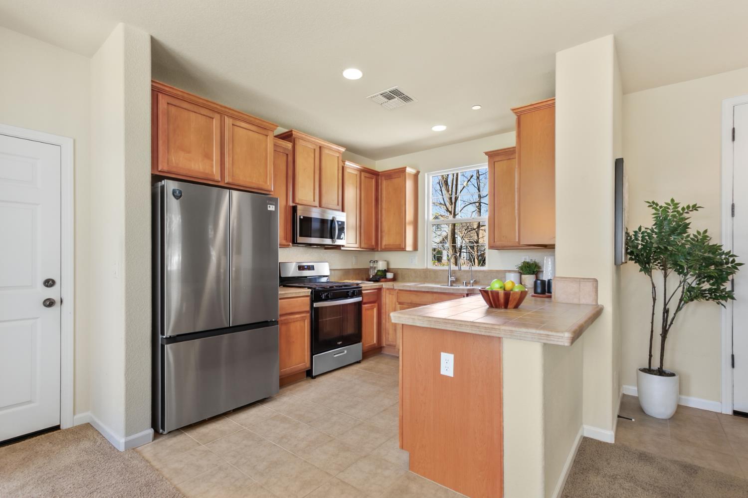 2128 Ragen Place Woodland, CA 95776 - Photo 13 of 40 a kitchen with stainless steel appliances granite countertop a refrigerator and a sink