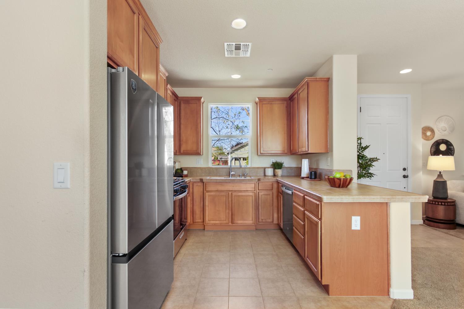 2128 Ragen Place Woodland, CA 95776 - Photo 14 of 40 a kitchen with a stove top oven sink and cabinets
