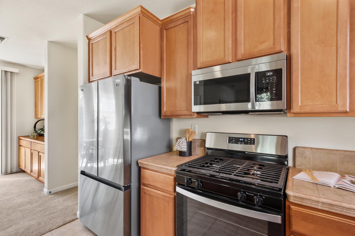 2128 Ragen Place Woodland, CA 95776 - Photo 17 of 40 a kitchen with stainless steel appliances granite countertop a refrigerator stove and microwave