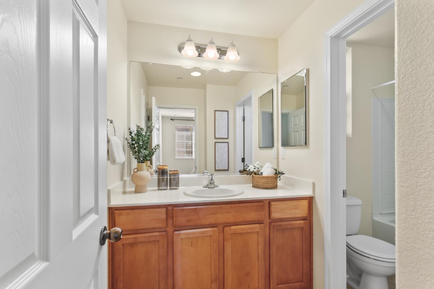 2128 Ragen Place Woodland, CA 95776 - Photo 23 of 40 a bathroom with a double vanity sink and a mirror