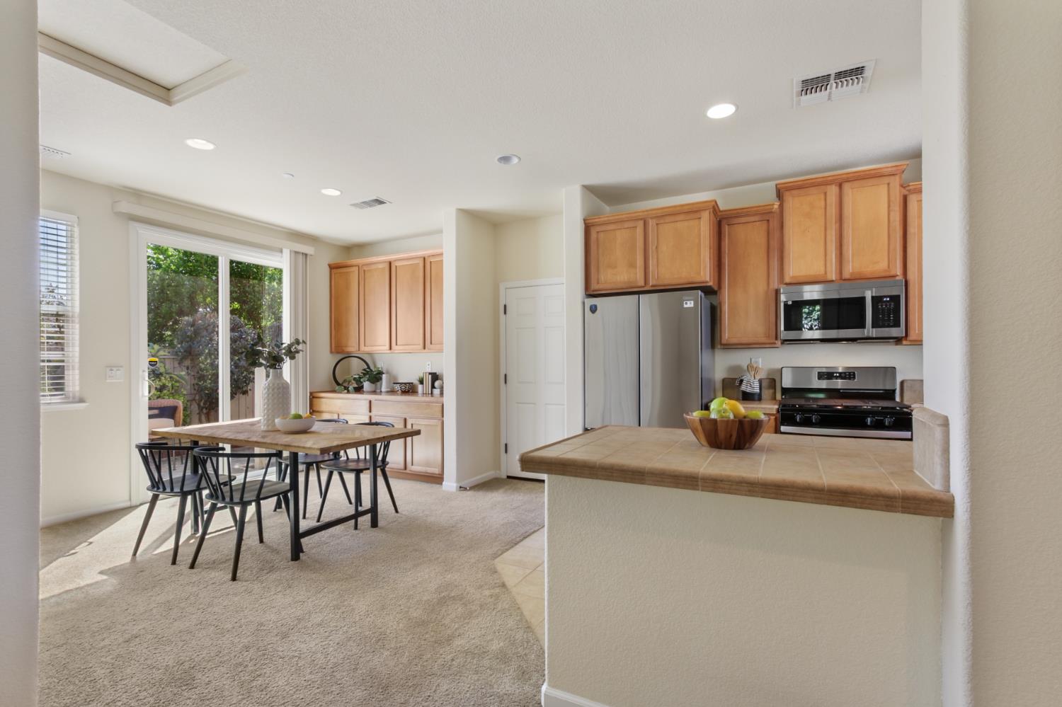 2128 Ragen Place Woodland, CA 95776 - Photo 9 of 40 a kitchen with a table chairs stove and refrigerator
