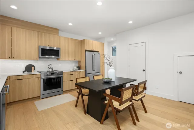 a kitchen with a stove a sink a microwave a counter top space and cabinets